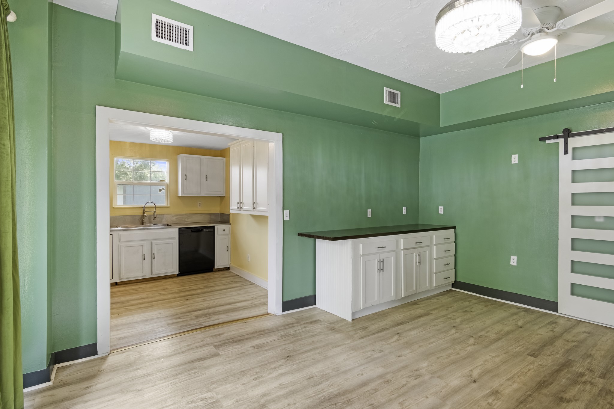 1200 4th Street Palacios, TX 77465 - Photo 13 of 44 a view of a kitchen with a sink and dishwasher cabinets