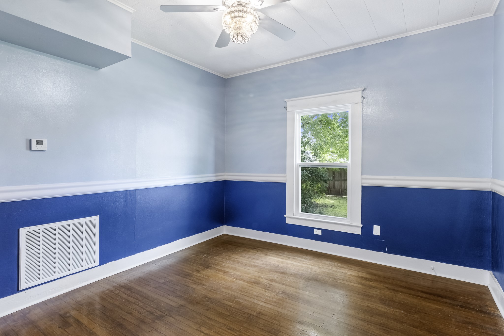 1200 4th Street Palacios, TX 77465 - Photo 17 of 44 wooden floor in an empty room with a window