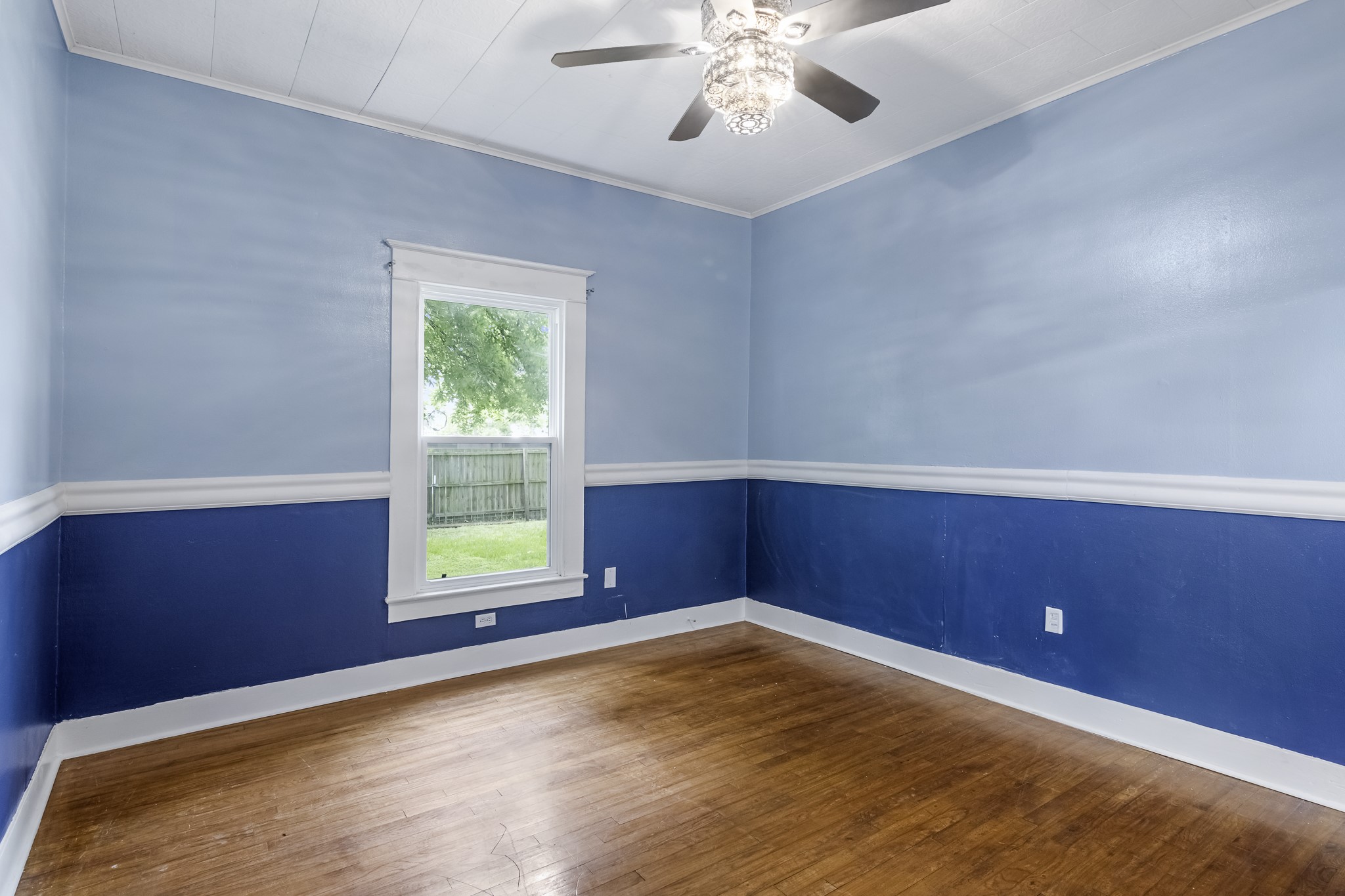 1200 4th Street Palacios, TX 77465 - Photo 20 of 44 a view of an empty room with wooden floor and a window