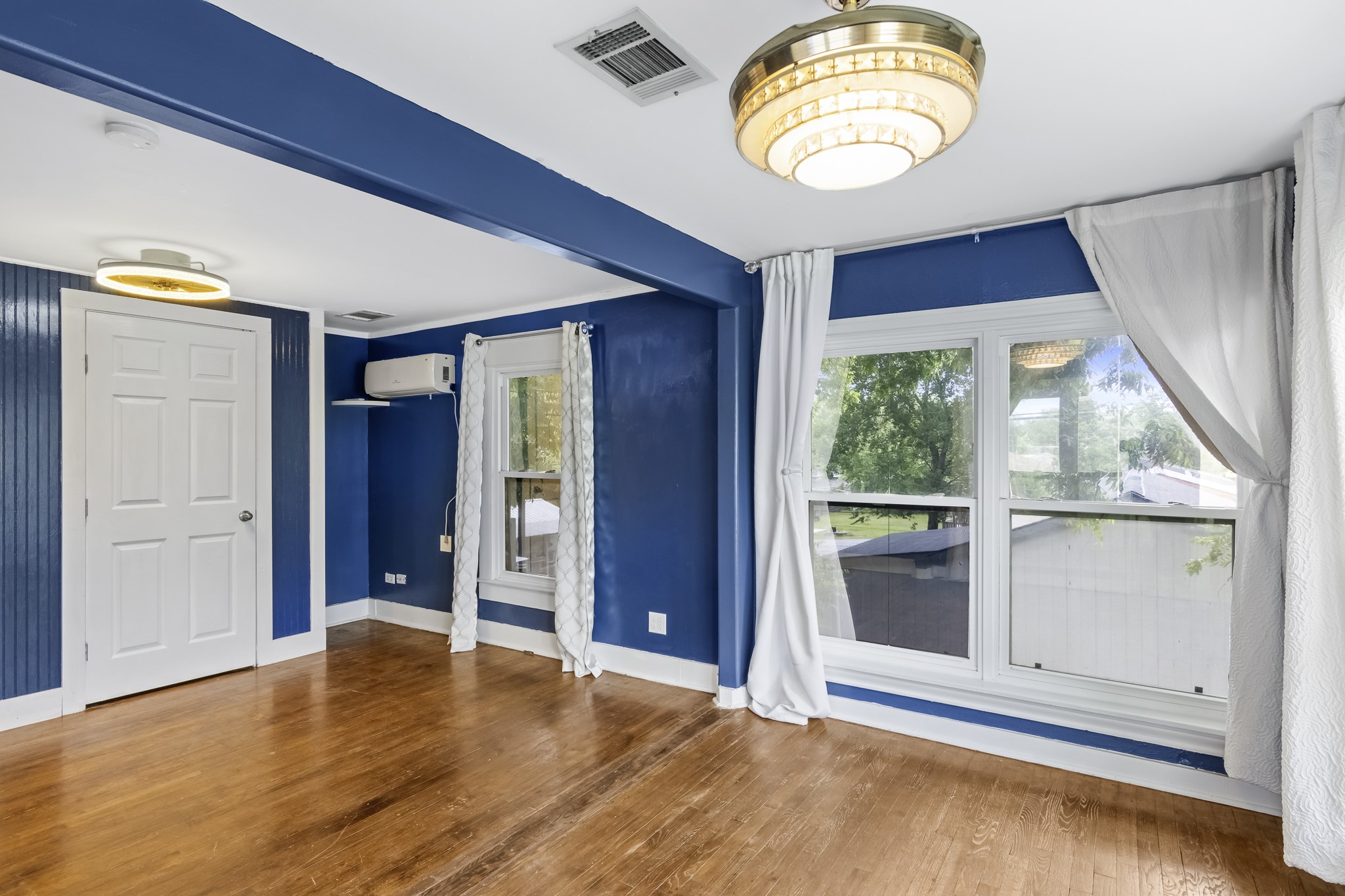1200 4th Street Palacios, TX 77465 - Photo 26 of 44 an empty room with wooden floor and windows