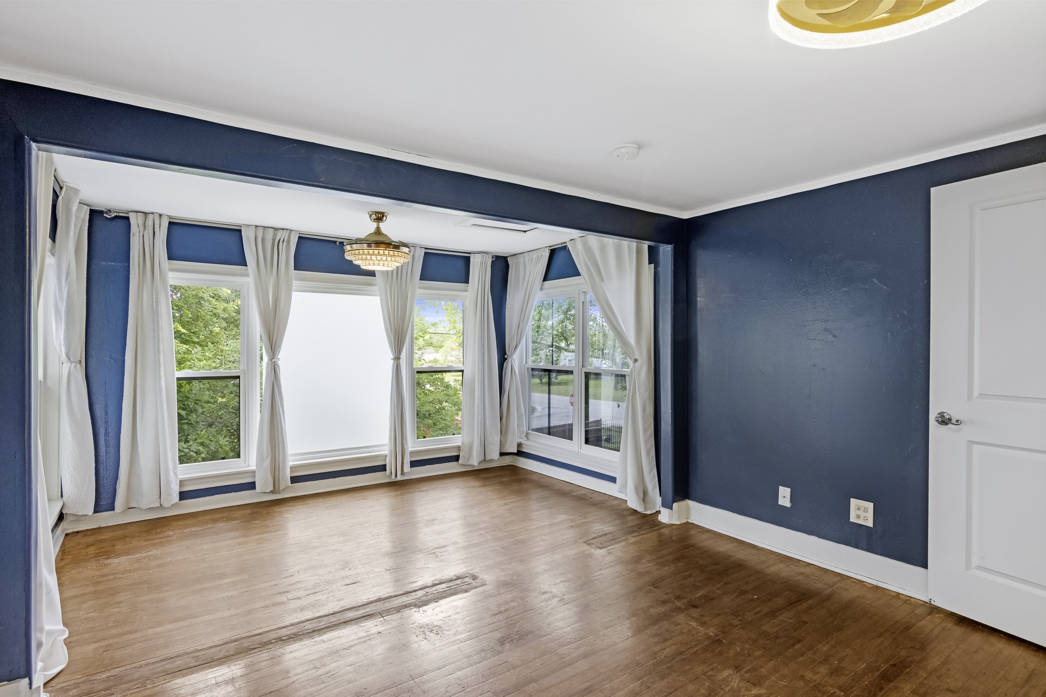 1200 4th Street Palacios, TX 77465 - Photo 28 of 44 an empty room with wooden floor and windows