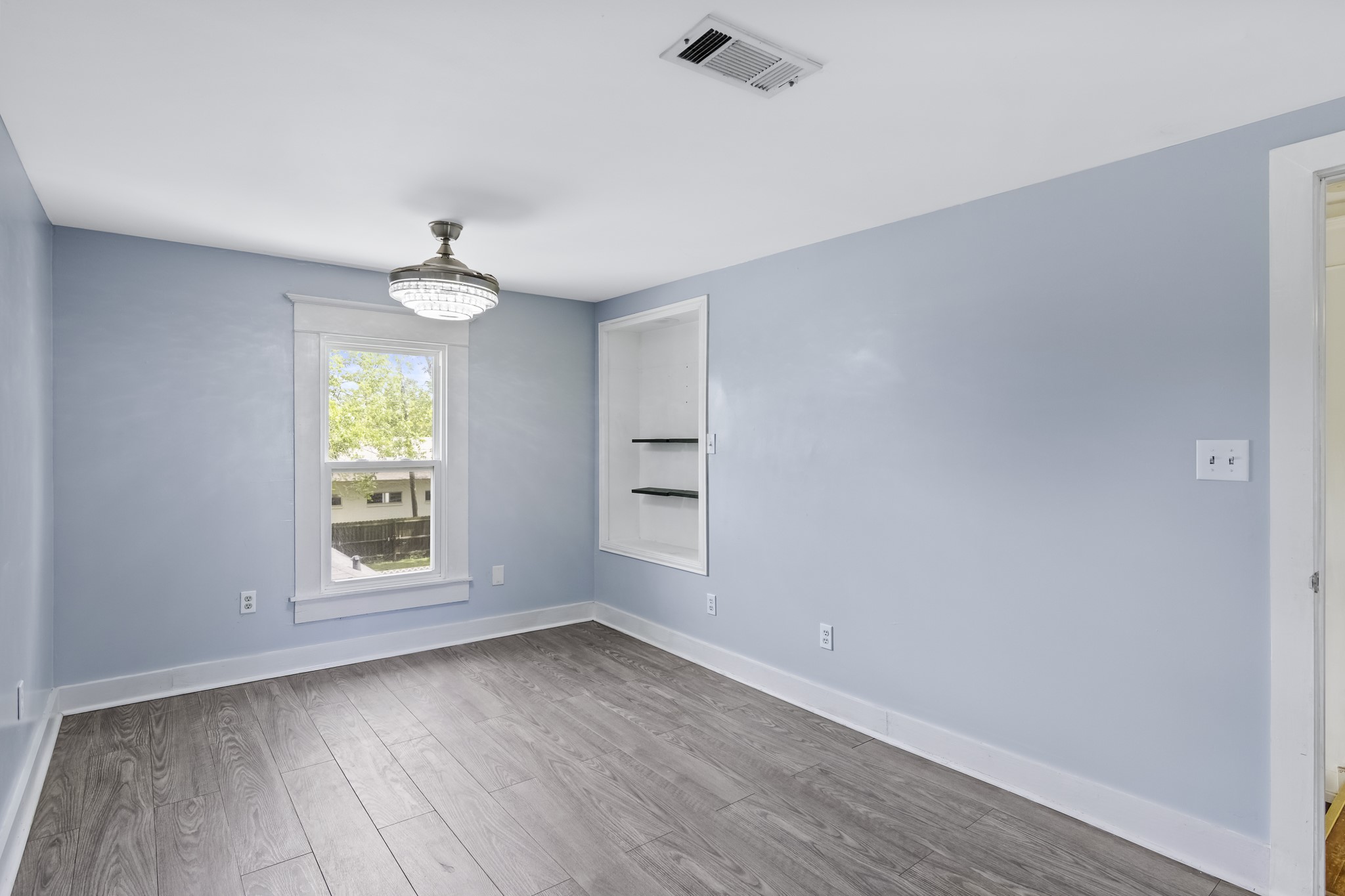 1200 4th Street Palacios, TX 77465 - Photo 31 of 44 an empty room with wooden floor and windows