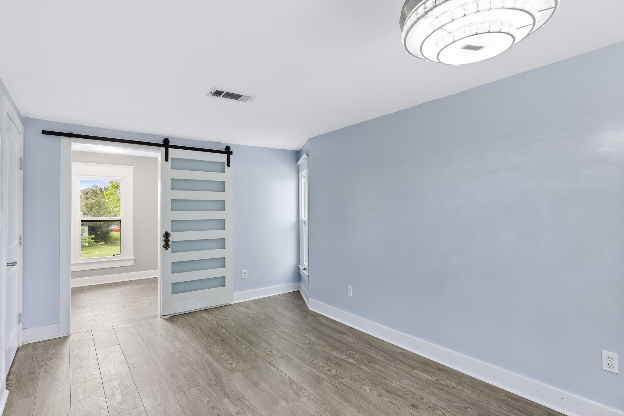 1200 4th Street Palacios, TX 77465 - Photo 32 of 44 an empty room with wooden floor and windows
