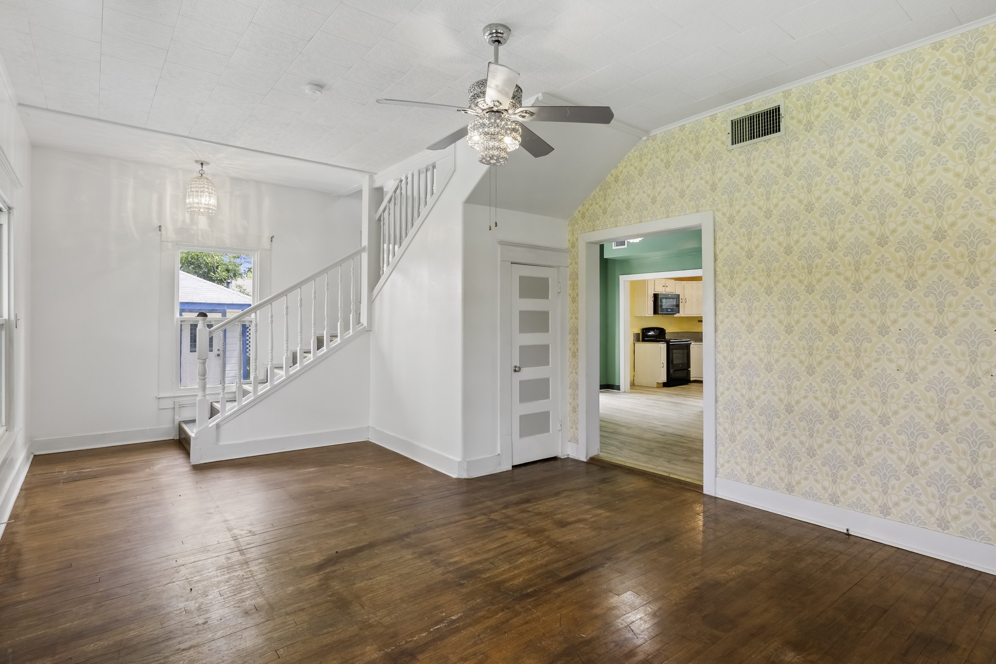 1200 4th Street Palacios, TX 77465 - Photo 6 of 44 a view interior of a house with wooden floor stairs and a chandelier