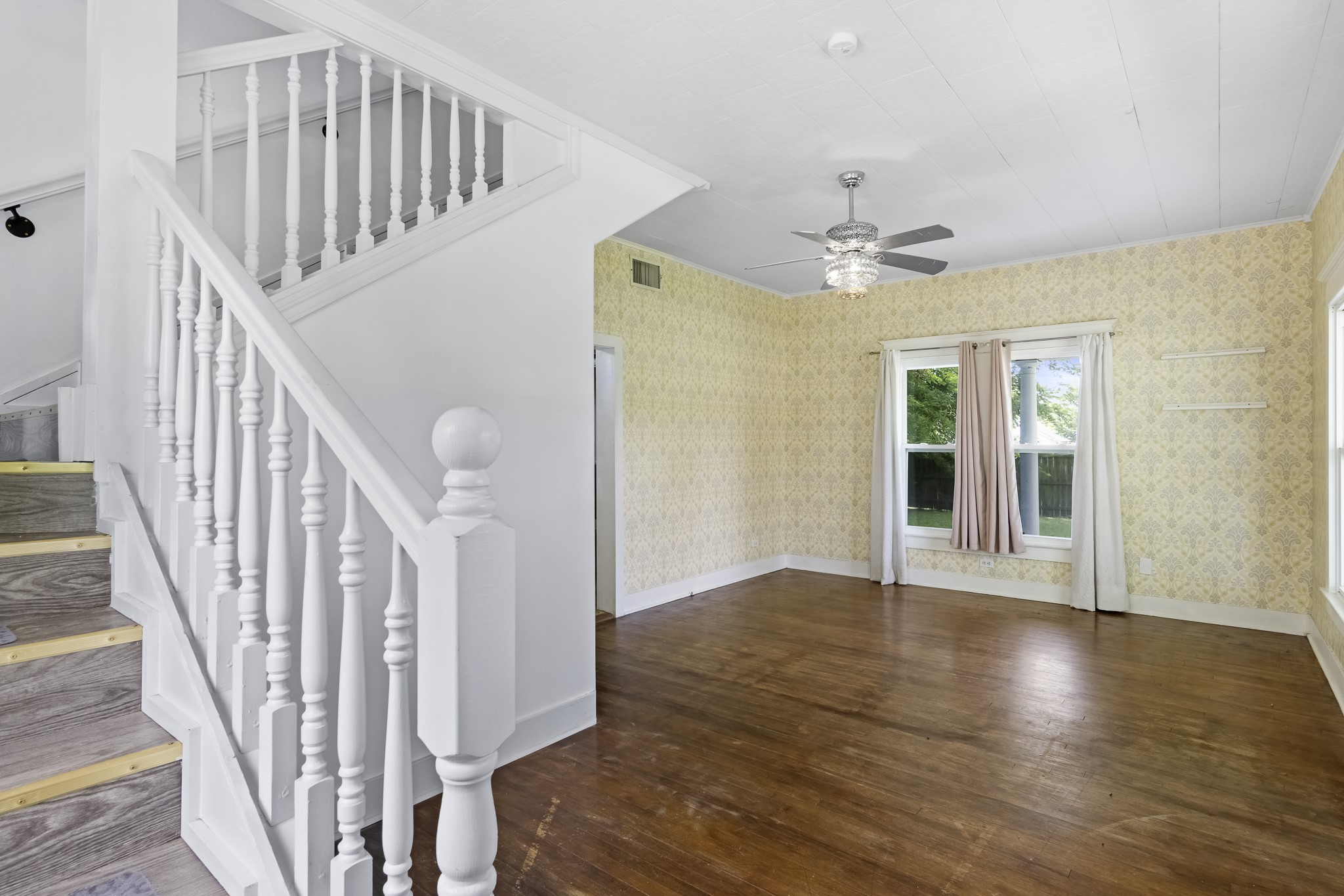 1200 4th Street Palacios, TX 77465 - Photo 9 of 44 a view of staircase with white walls and a ceiling fan