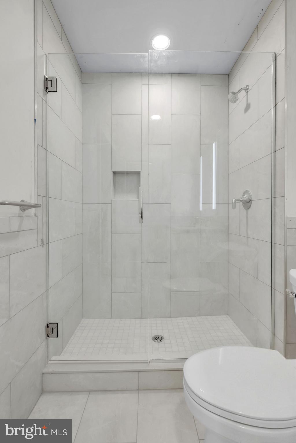 1801 Market Street, Unit 1817 Philadelphia, PA 19103 - Photo 13 of 77 a bathroom with a shower and a toilet