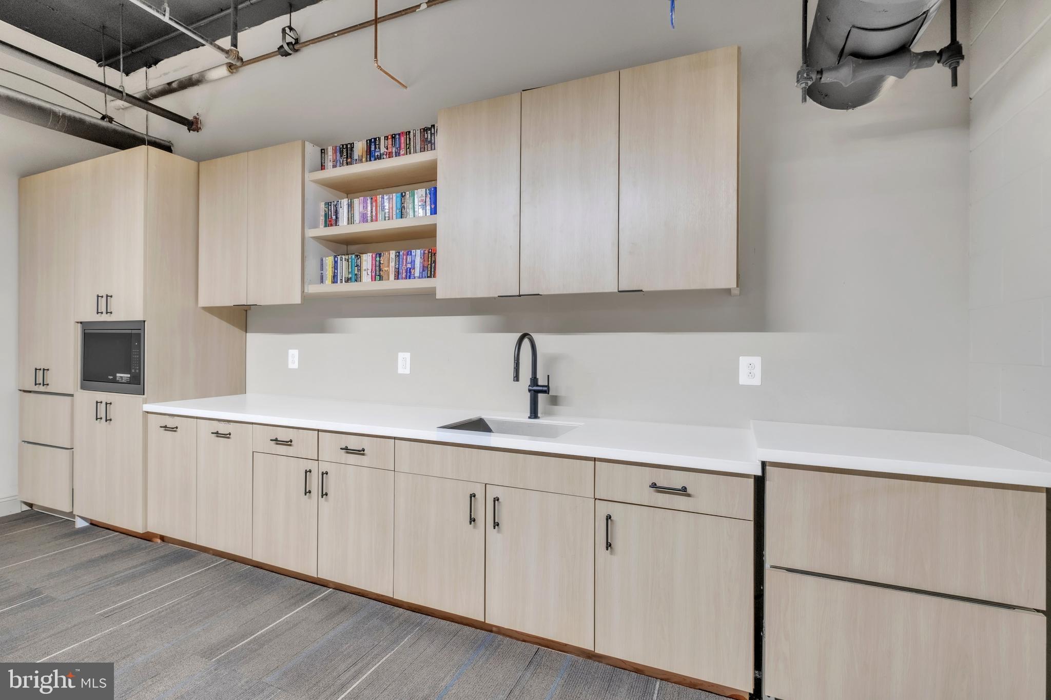 1801 Market Street, Unit 1817 Philadelphia, PA 19103 - Photo 21 of 77 a kitchen with white cabinets and sink