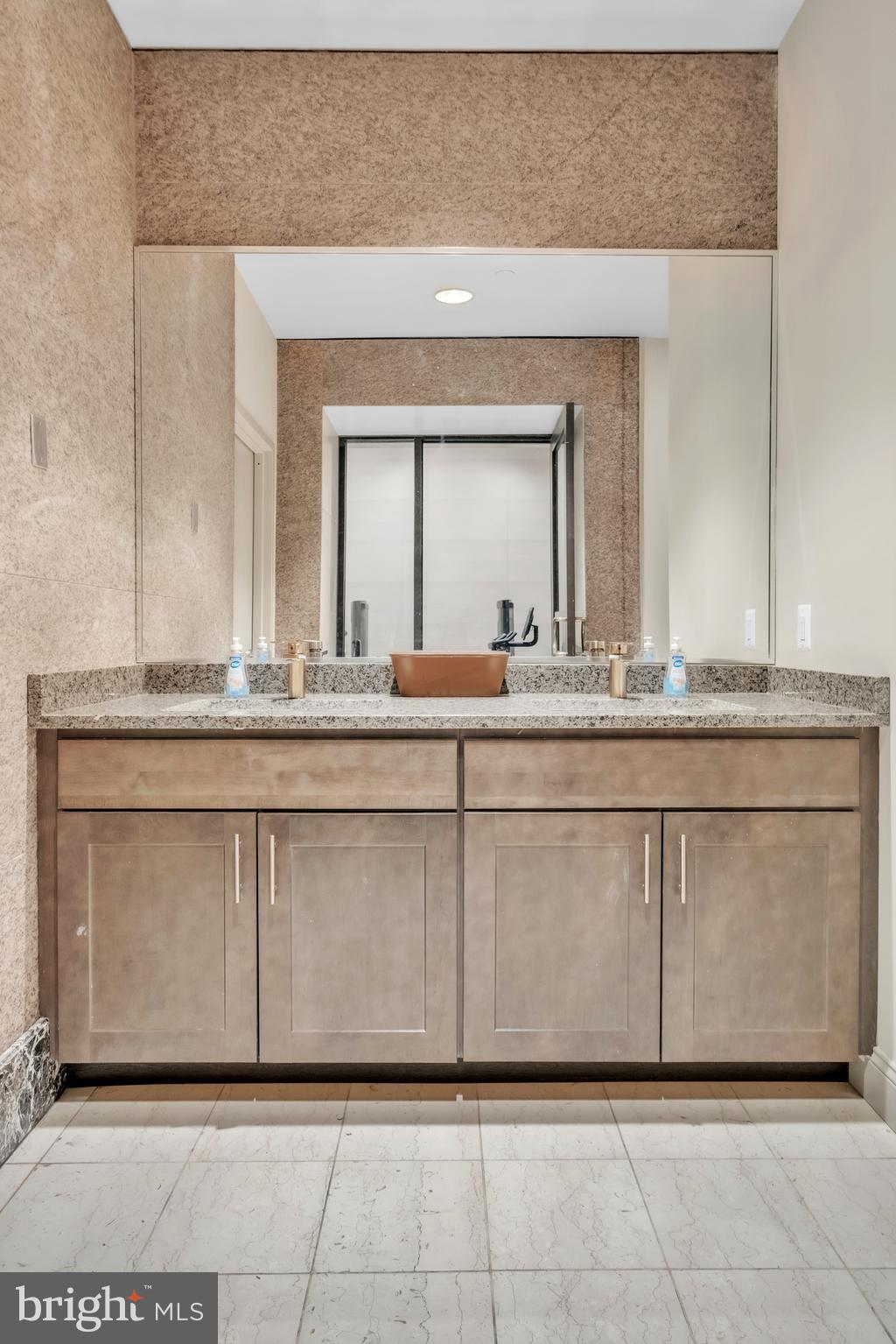 1801 Market Street, Unit 1817 Philadelphia, PA 19103 - Photo 35 of 77 a bathroom with a sink and a mirror