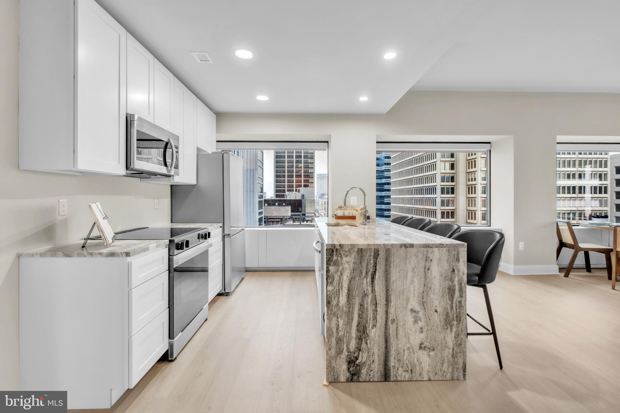 1801 Market Street, Unit 1817 Philadelphia, PA 19103 - Photo 4 of 77 a living room with stainless steel appliances kitchen island granite countertop furniture and a kitchen view