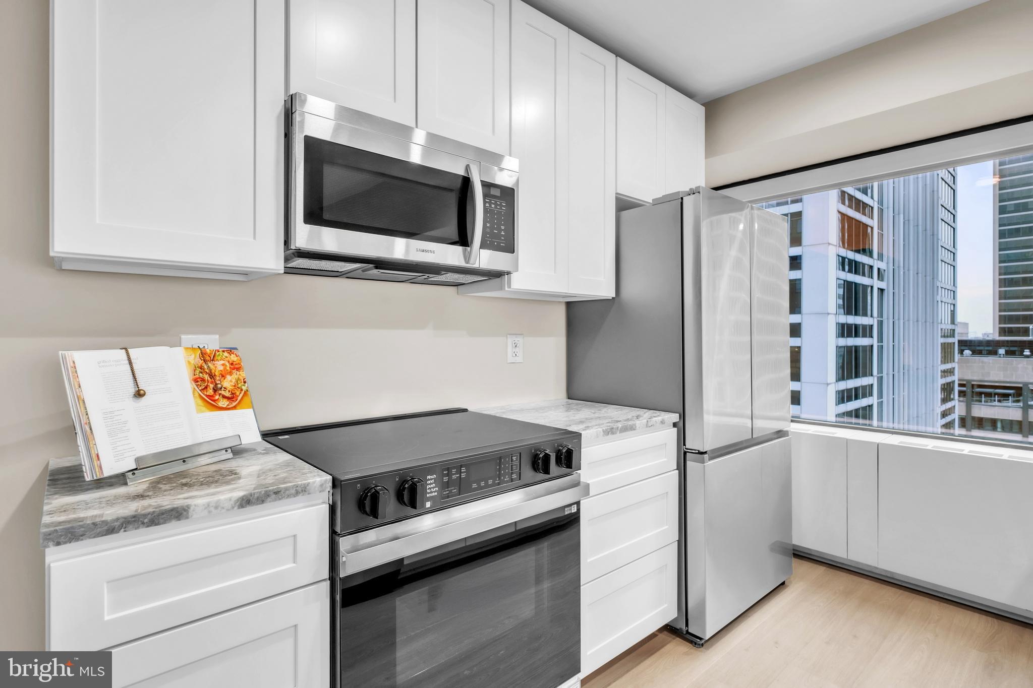 1801 Market Street, Unit 1817 Philadelphia, PA 19103 - Photo 5 of 77 a kitchen with a stove and a microwave