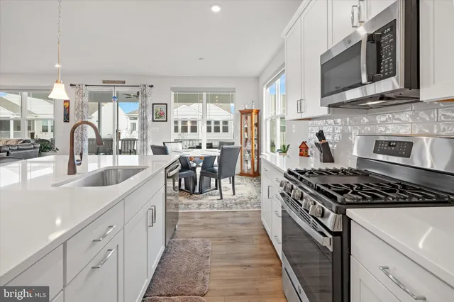a hallway with a stove and a refrigerator