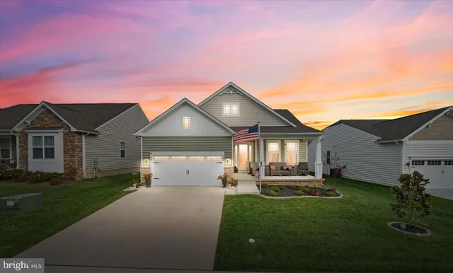 a living room with furniture a flat screen tv and a table