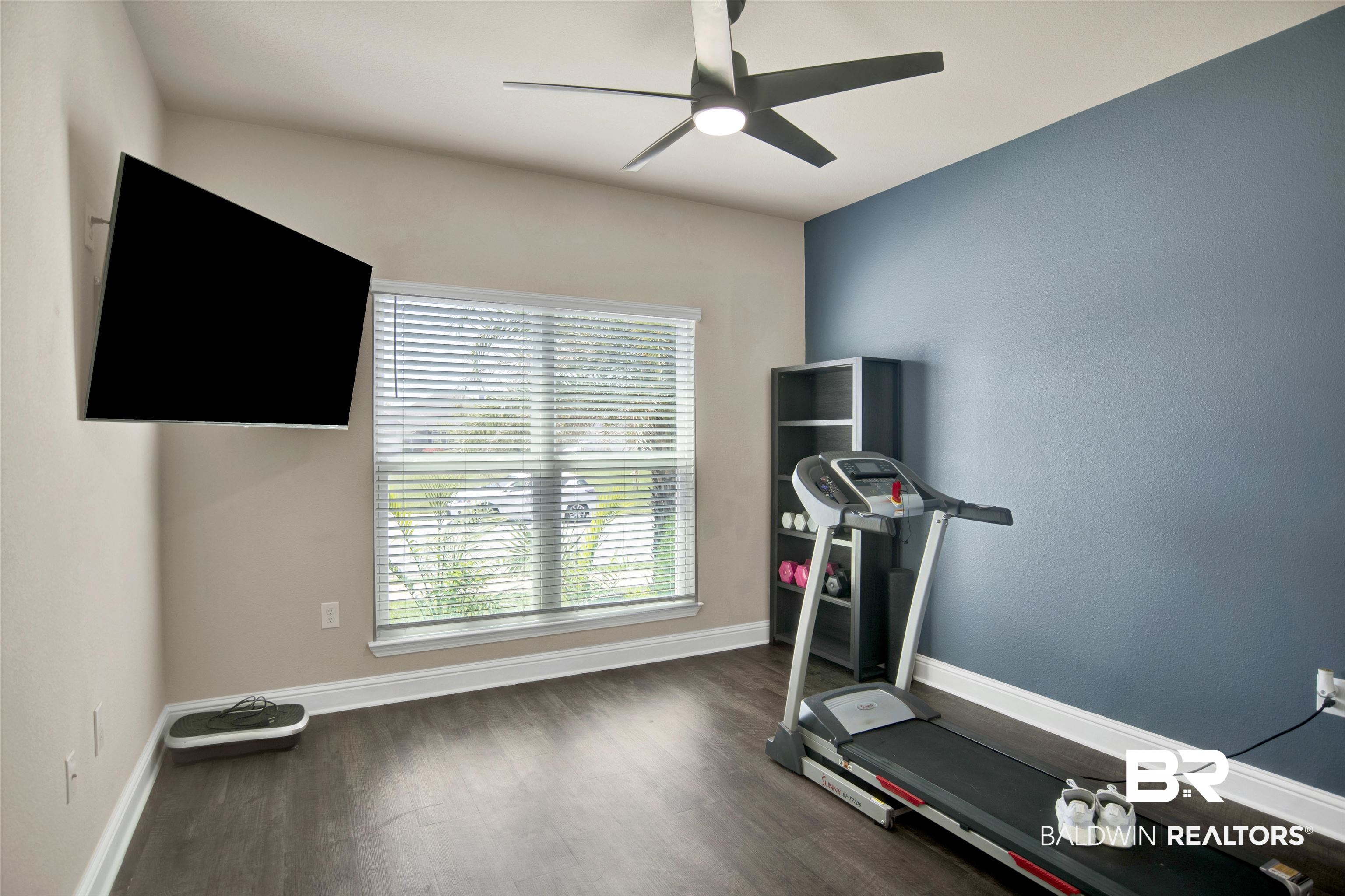 8493 Bronze Lane Foley, AL 36535 - Photo 26 of 38 Interior room featuring sloped ceilings, wood-finish flooring, and a window with blinds