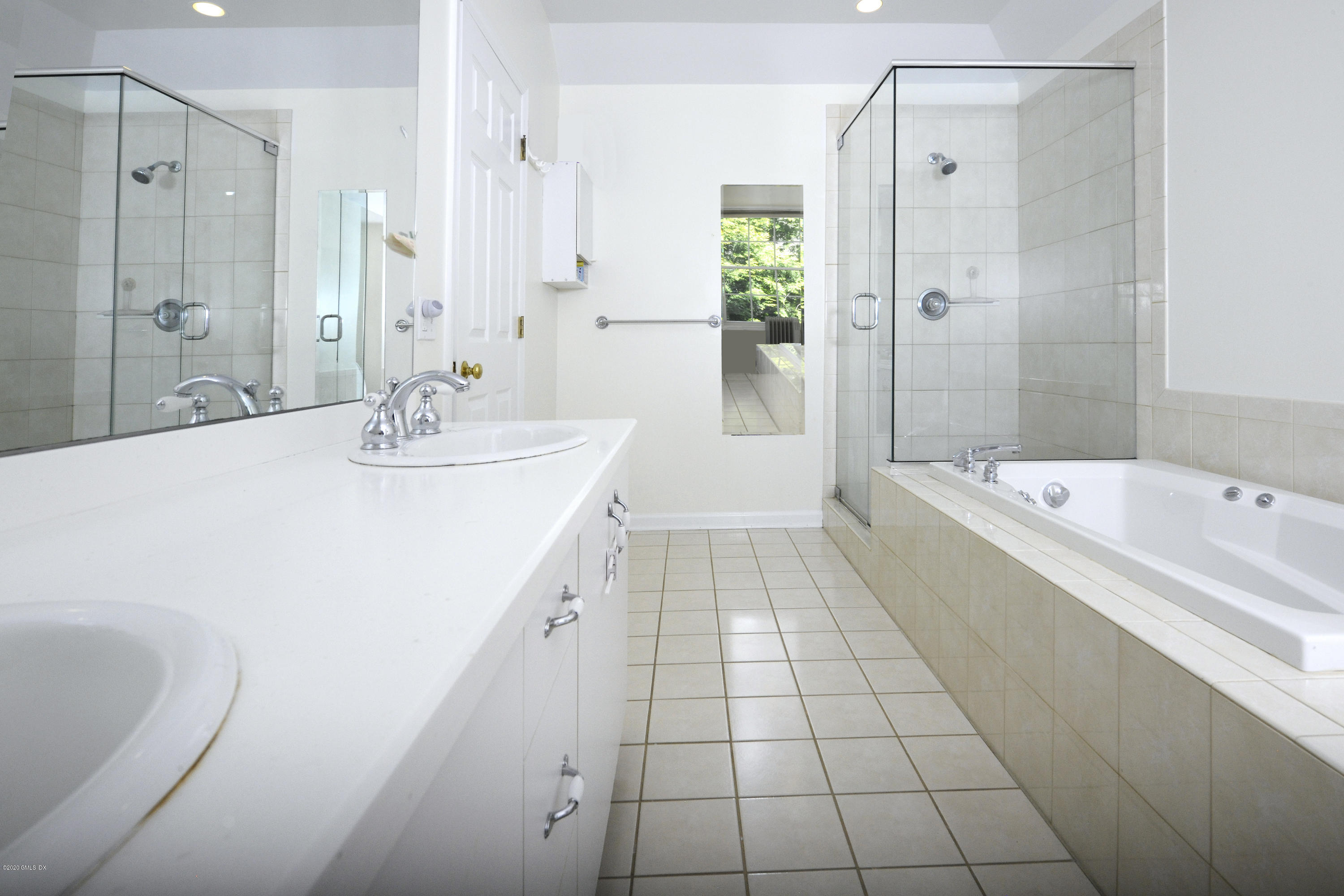 48 Spring Street, Unit 10 Greenwich, CT 06830 - Photo 7 of 11 a bathroom with a tub sink and mirror