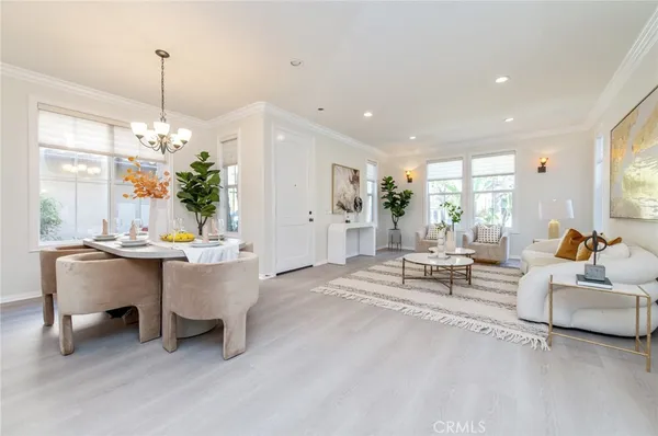 a living room with furniture a window and a chandelier