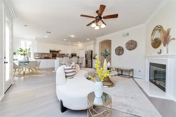 a kitchen with kitchen island white cabinets and stainless steel appliances