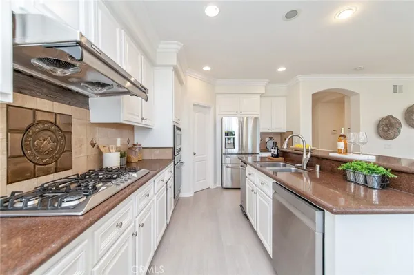 a kitchen with stainless steel appliances a white stove top oven and a refrigerator