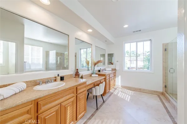 a spacious bathroom with a granite countertop sink and a mirror