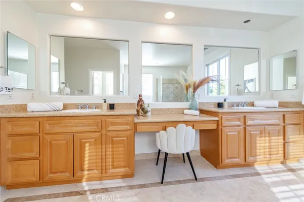 a bathroom with a granite countertop sink a mirror and shower