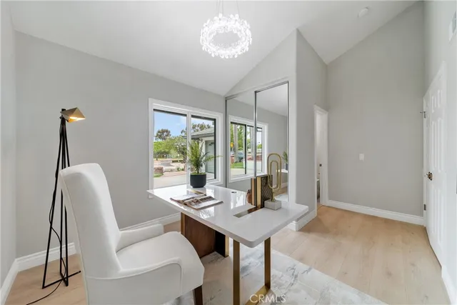 a view of a dining room with furniture wooden floor and a chandelier