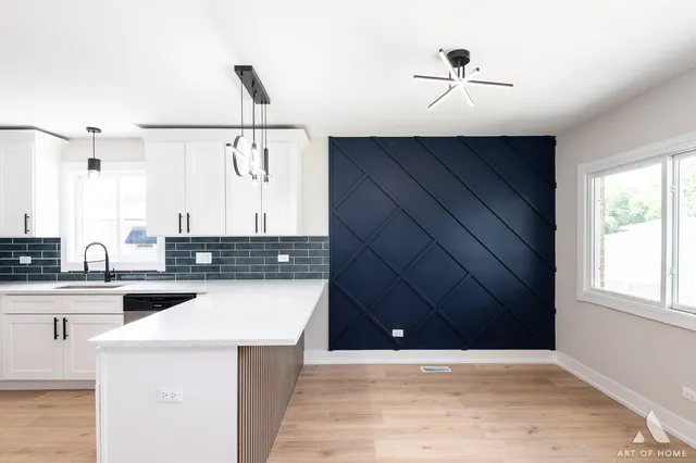 a kitchen with a sink cabinets and window