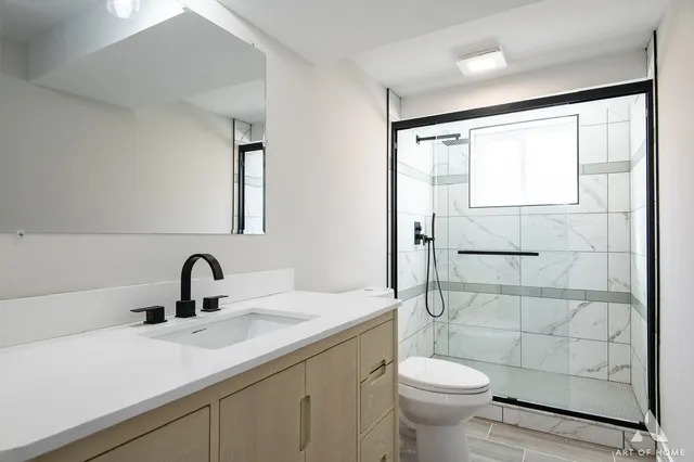 a kitchen with a sink cabinets and wooden floor
