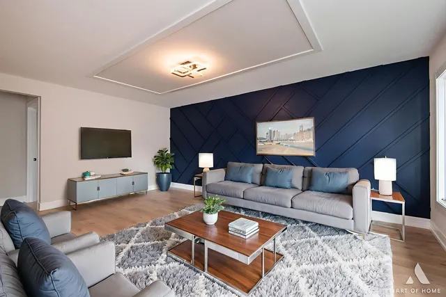 a living room with furniture a rug and a flat screen tv