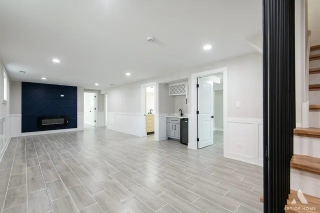 a bathroom with a granite countertop sink toilet and painting on the wall