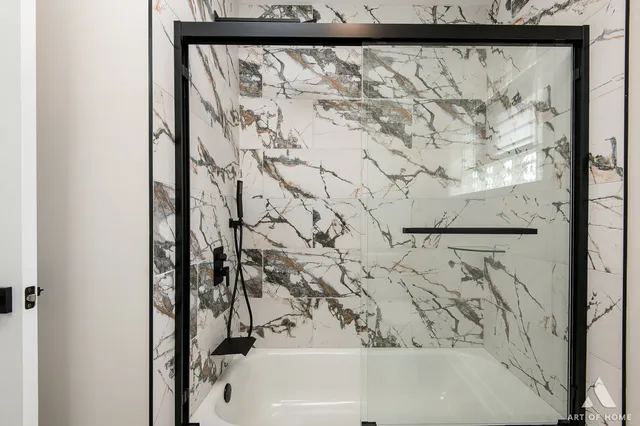 a white house that has tree in front of it