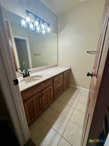 a spacious bathroom with a double vanity sink a large mirror and a vanity