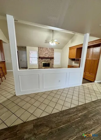 a kitchen with granite countertop a sink and a stove top oven