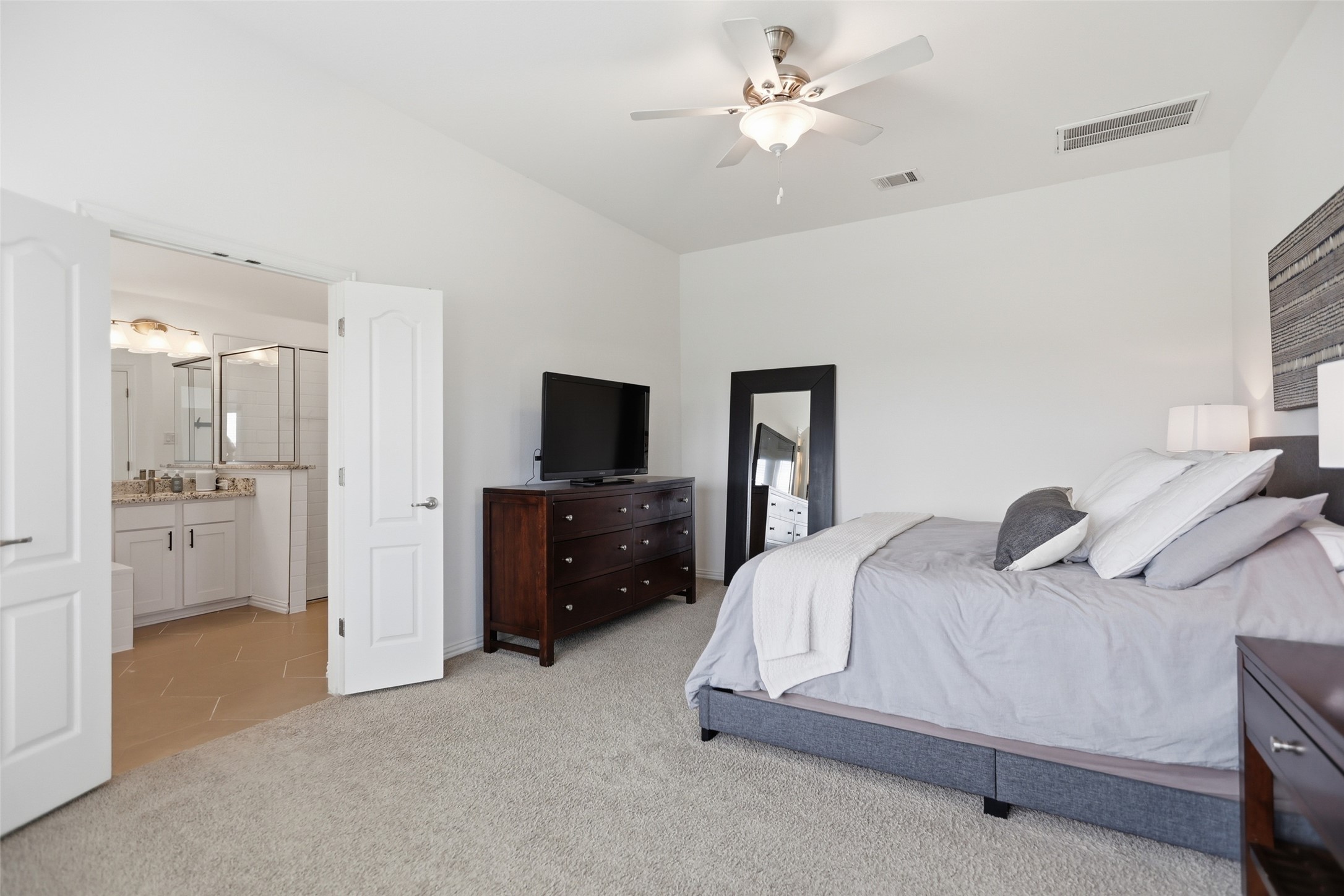 544 Cherrystone Loop Buda, TX 78610 - Photo 15 of 40 a bedroom with a bed and a tv