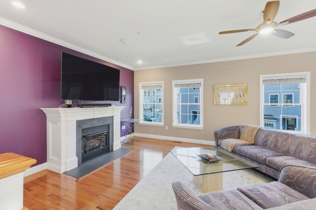 66 Compass Point, Unit 66 North Andover, MA 01845 - Photo 23 of 42 a living room with furniture flat screen tv and a fireplace