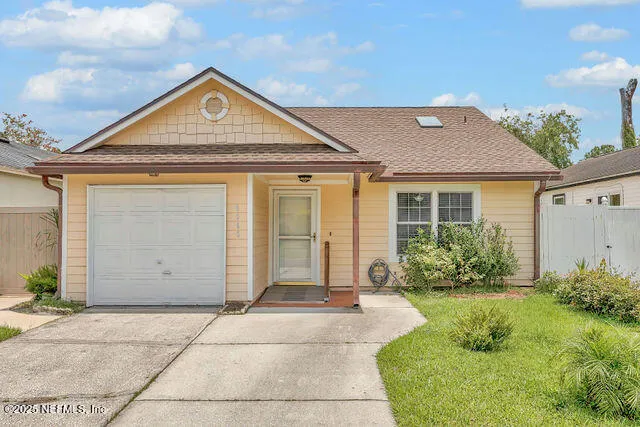 a front view of a house with a garden
