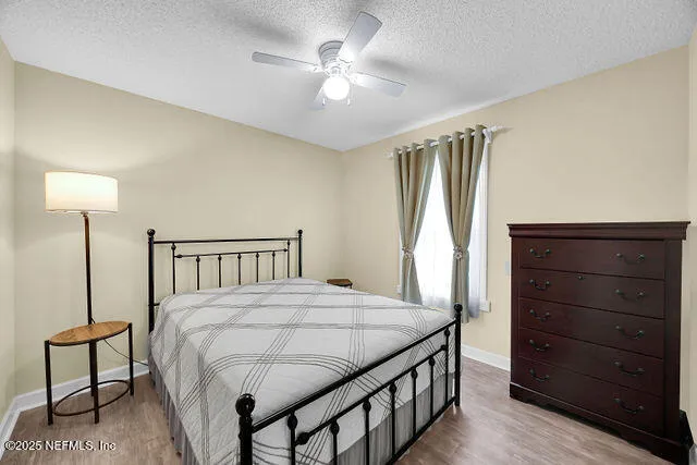 a view of backyard with wooden fence and seating space