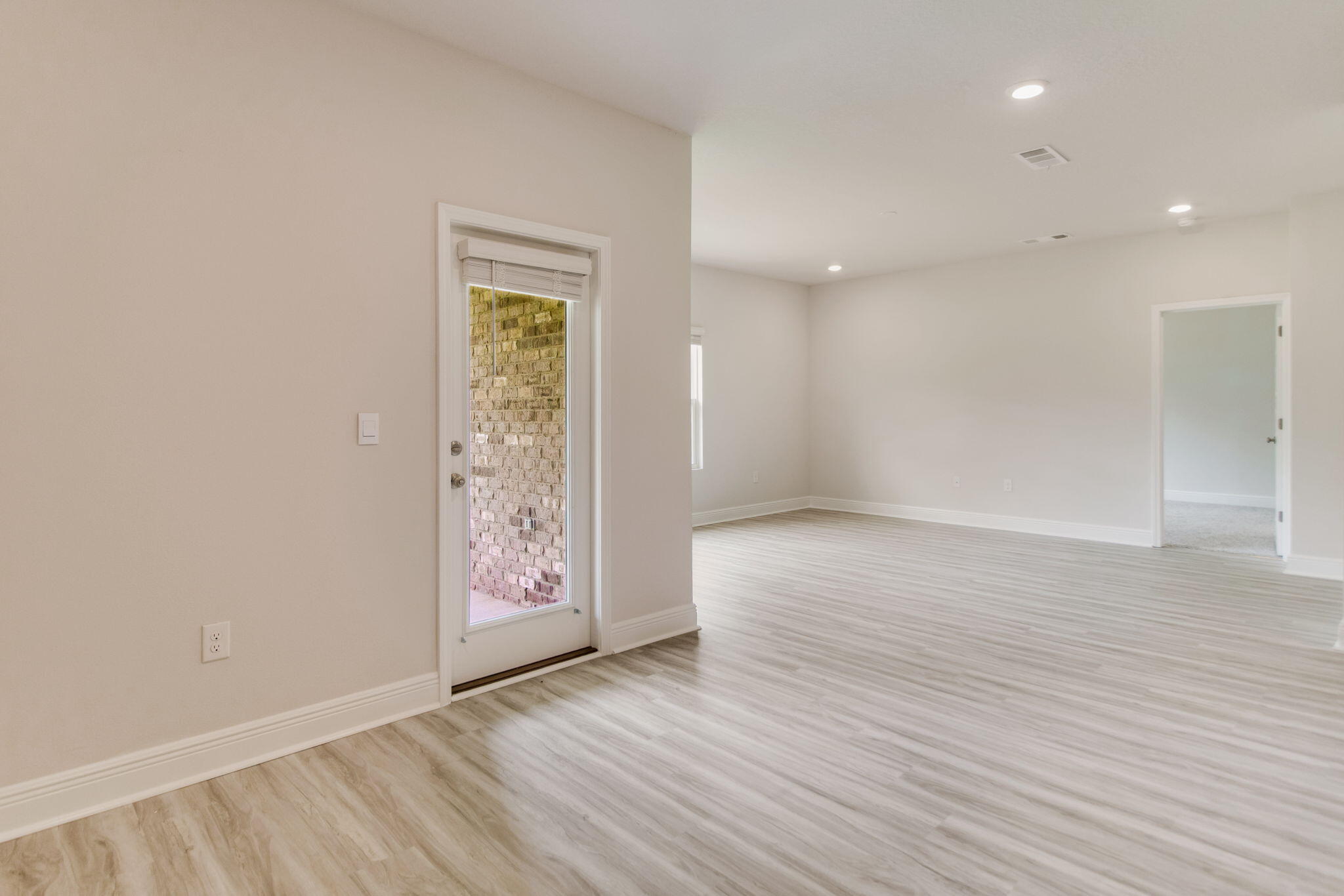 8724 Bluebell Street Milton, FL 32583 - Photo 10 of 32 wooden floor in an empty room with a window
