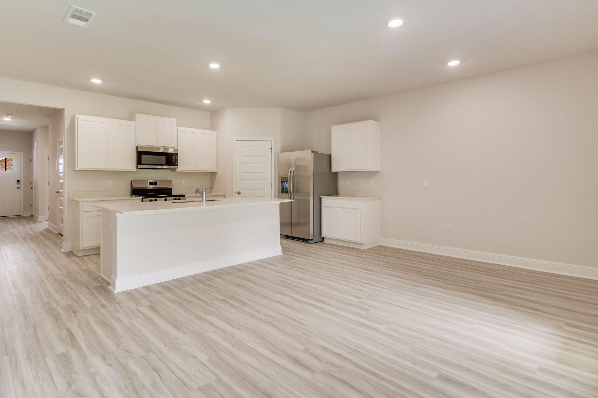 8724 Bluebell Street Milton, FL 32583 - Photo 6 of 32 a kitchen with stainless steel appliances a refrigerator sink and microwave