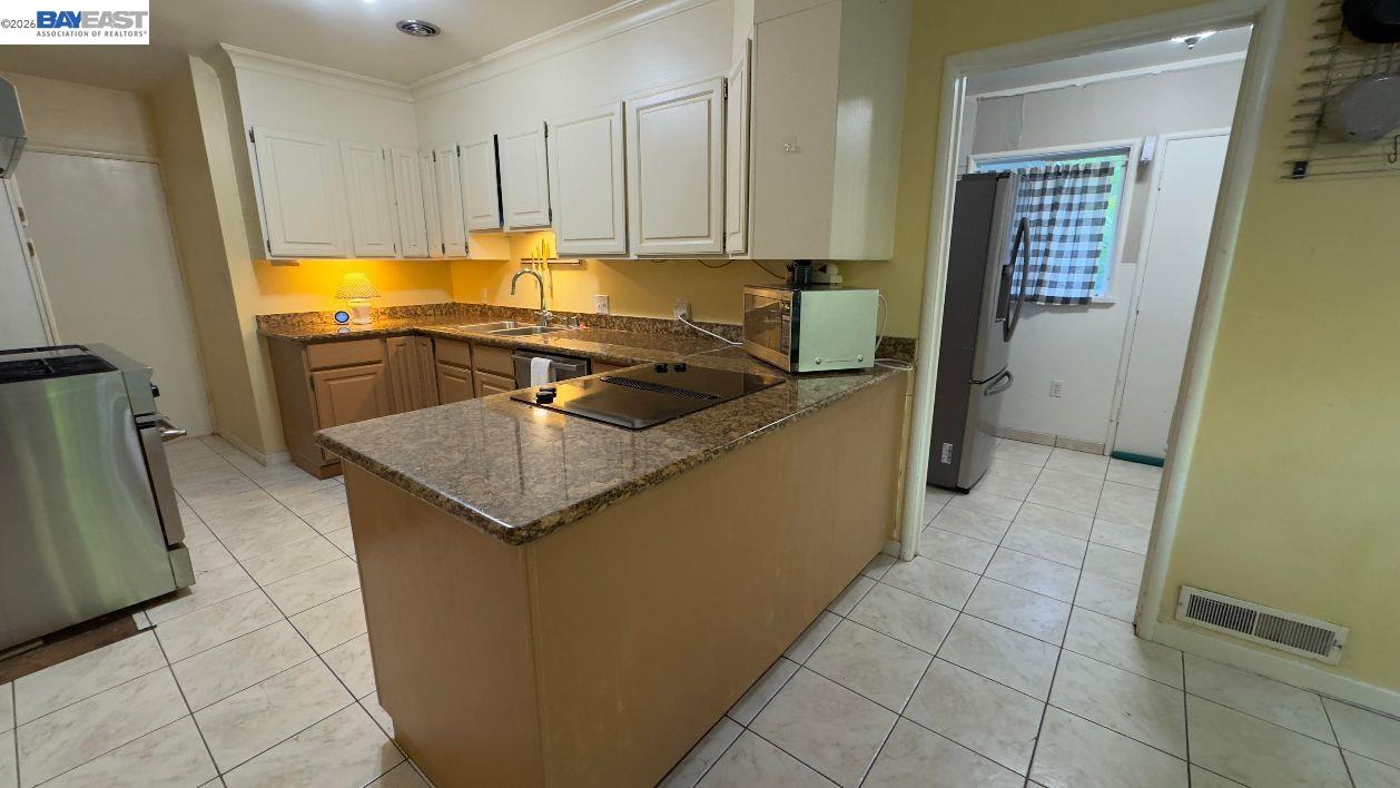 190 Alderwood Road Walnut Creek, CA 94598 - Photo 9 of 29 a kitchen with granite countertop a sink and a stove top oven