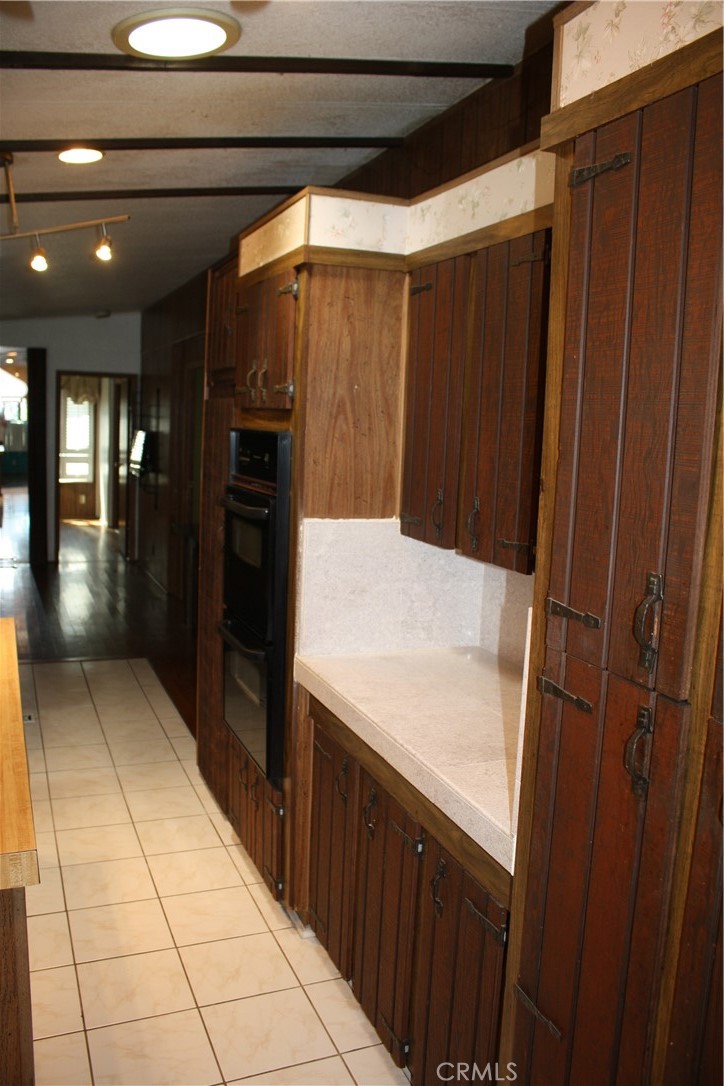 17700 South Avalon, Unit 411 Carson, CA 90746 - Photo 16 of 39 a kitchen with a wooden floor and entryway