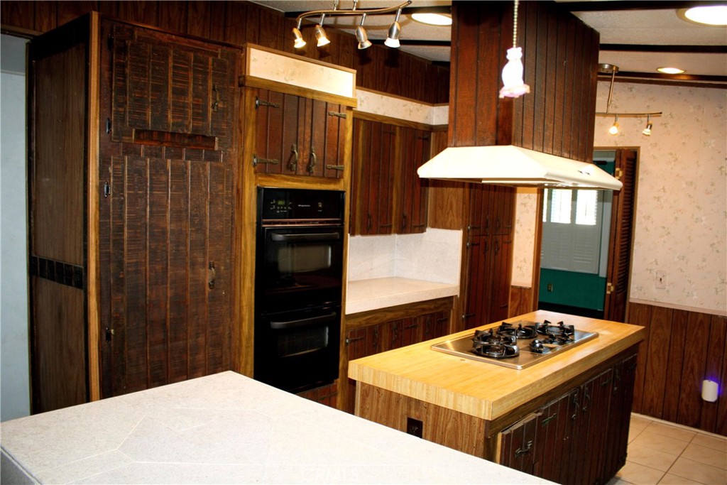 17700 South Avalon, Unit 411 Carson, CA 90746 - Photo 19 of 39 a kitchen view of a kitchen island a stove a refrigerator and a stove