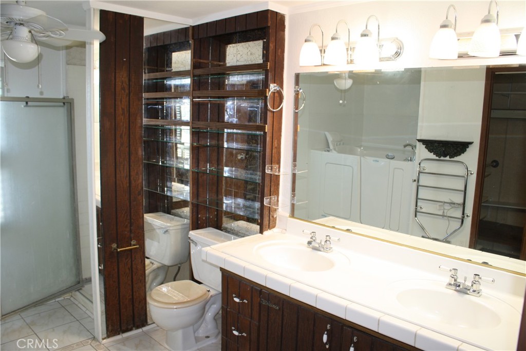 17700 South Avalon, Unit 411 Carson, CA 90746 - Photo 30 of 39 a bathroom with a sink toilet and shower