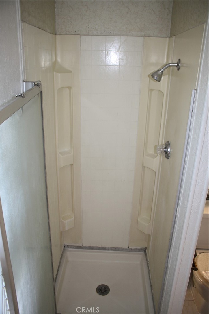 17700 South Avalon, Unit 411 Carson, CA 90746 - Photo 31 of 39 a bathroom with a glass door shower