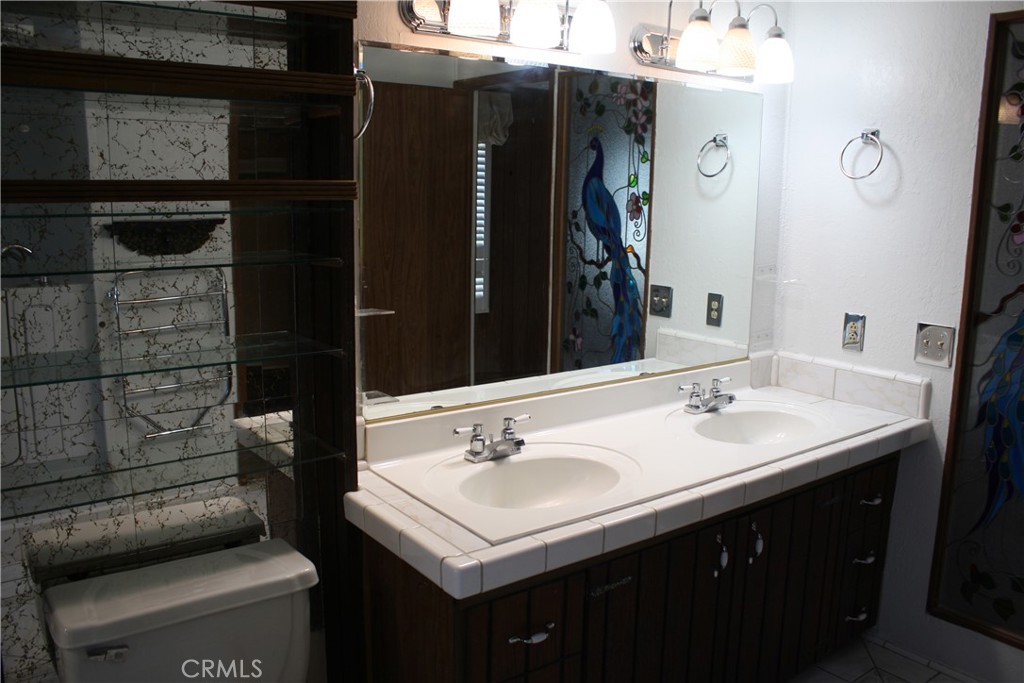 17700 South Avalon, Unit 411 Carson, CA 90746 - Photo 33 of 39 a bathroom with a sink a toilet and shower