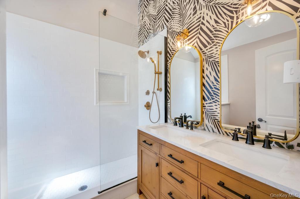 357 Wynsum Avenue Merrick, NY 11566 - Photo 34 of 40 a bathroom with a sink a mirror and a shower