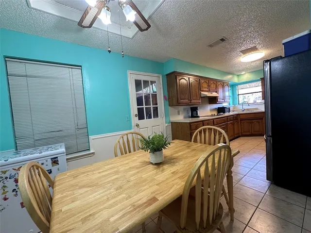 a view of a dining room with furniture and a chandelier