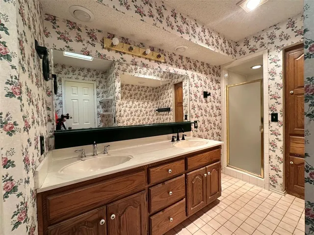 a bathroom with a sink double vanity and a mirror