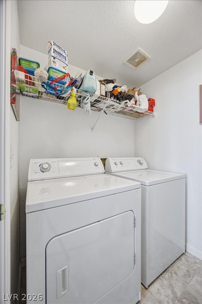 10550 West Alexander Road, Unit 2164 Las Vegas, NV 89129 - Photo 22 of 27 Functional laundry room equipped with essential appliances and convenient overhead shelving.