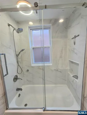 a bathroom with a bath tub and shower