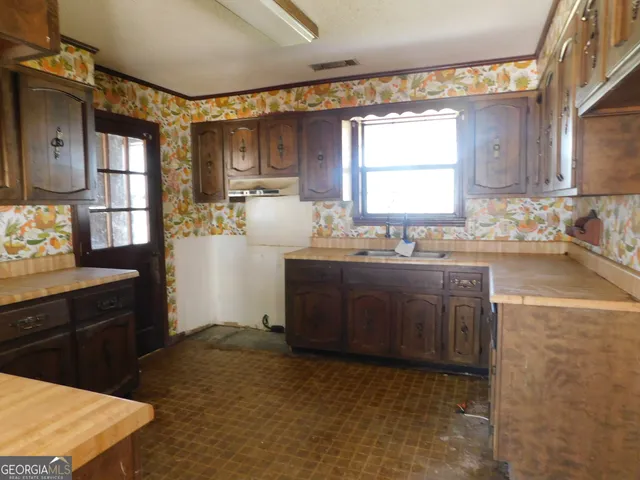 a kitchen with granite countertop a sink cabinets and window