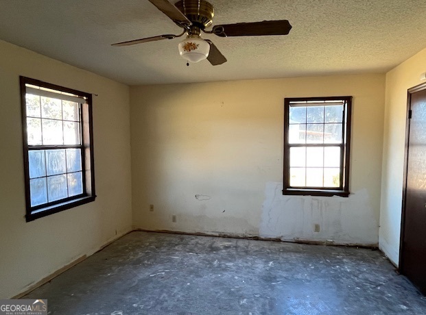 563 Keith Road Guyton, GA 31312 - Photo 7 of 13 an empty room with windows and fan